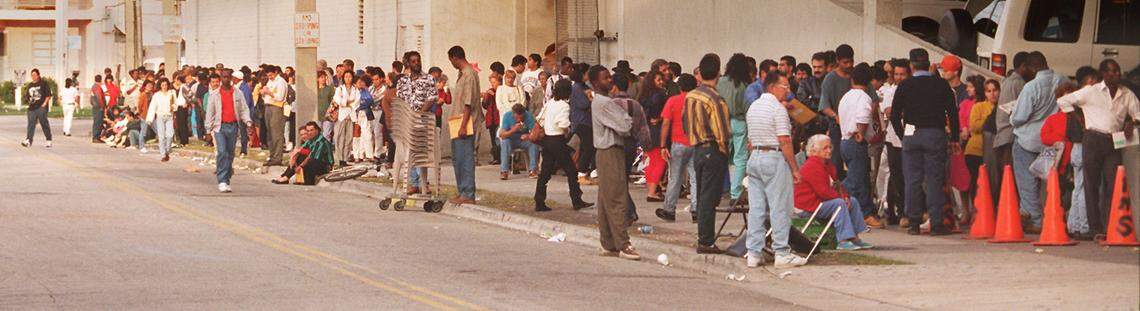 In 1995, Immigrants line up outside the INS building at 79th and Biscayne to get a number to come back for processing.