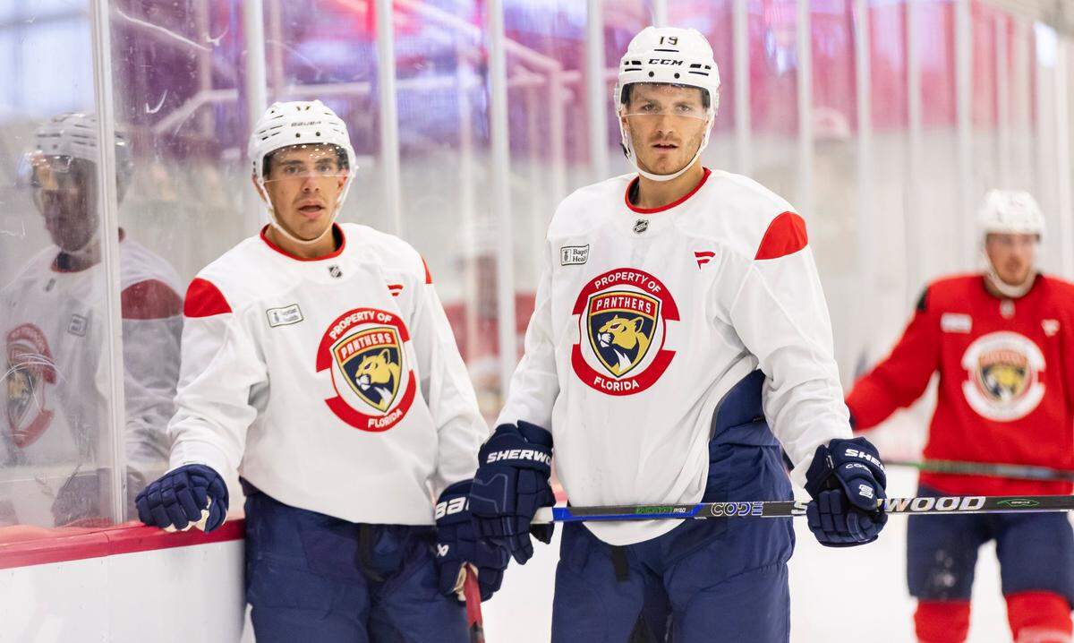 Florida Panthers forwards Matthew Tkachuk (19) and Evan Rodrigues (17) look on during training camp at the Baptist Health IcePlex on Thursday, Sept. 19, 2024, in Fort Lauderdale, Fla.