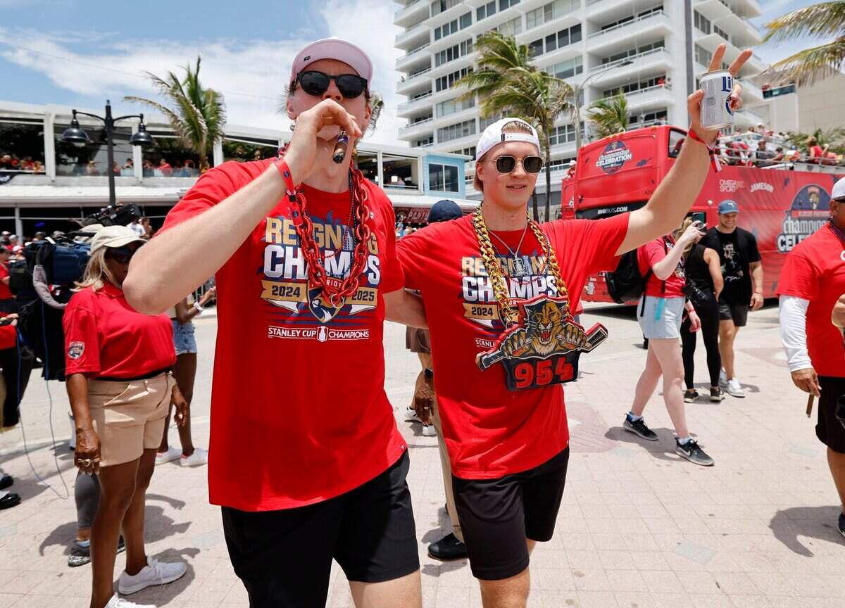 Florida Panthers defenseman Niko Mikkola (77) and Florida Panthers center Anton Lundell (15) greets fans during the Florida Panthers Stanley Cup victory parade and rally at the beach along A1A in Fort. Lauderdale, Florida on Sunday, June 22, 2025.