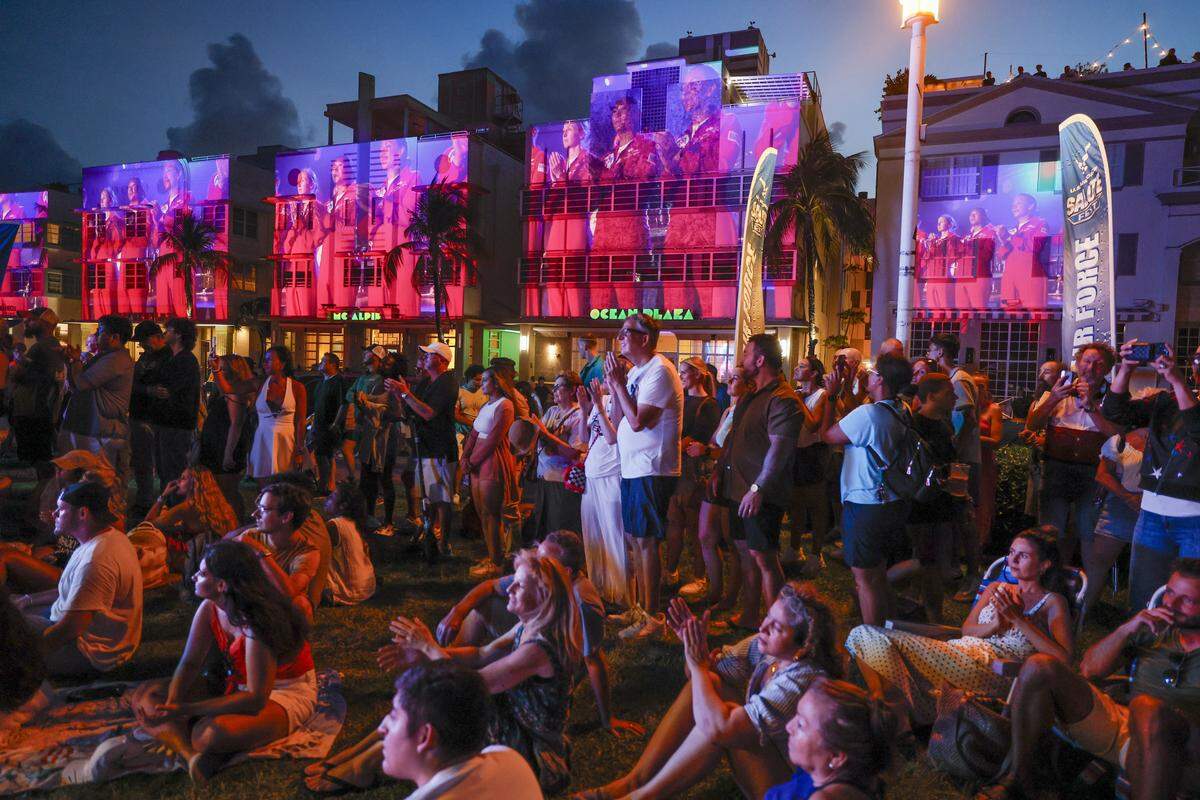 The U.S. Air Force Thunder Bird Team is projected on the facade of Art Deco Hotels along Ocean Drive as attendees celebrate during Memorial Day Weekend at the Hyundai Air & Sea Show in Miami Beach, Florida, on Saturday, May 23, 2026.