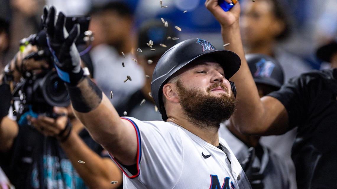 Miami Marlins base runner Jake Burger (36) is showered with sunflower seeds as he reacts with teammates after homering during the first inning of an MLB game against the Arizona Diamondbacks at LoanDepot Park on Wednesday, August 21, 2024, in Miami, Fla.