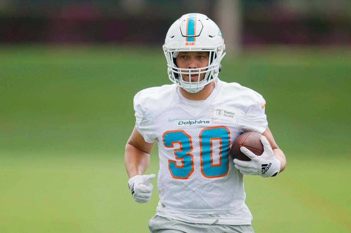 Miami Dolphins fullback Alec Ingold (30) runs with the football during mandatory minicamp at the Baptist Health Training Complex in Miami Gardens, Florida on Wednesday, June 7, 2023.