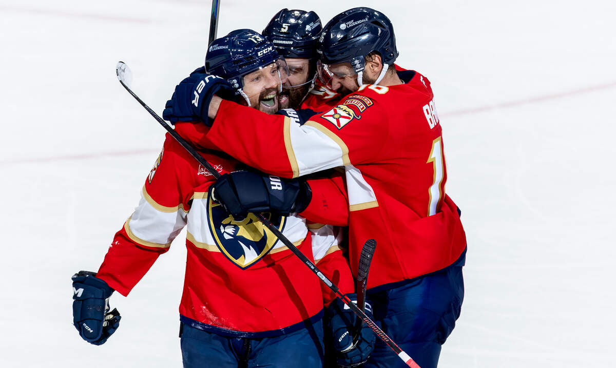 Florida Panthers center Sam Reinhart (13) celebrates with  Aaron Ekblad (5) and Aleksander Barkov (16) after scoring his fourth goal of the game against the Edmonton Oilers during the third period of Game 6 in the NHL Stanley Cup Final at Amerant Bank Arena on Tuesday, June 17, 2025, in Sunrise, Fla.