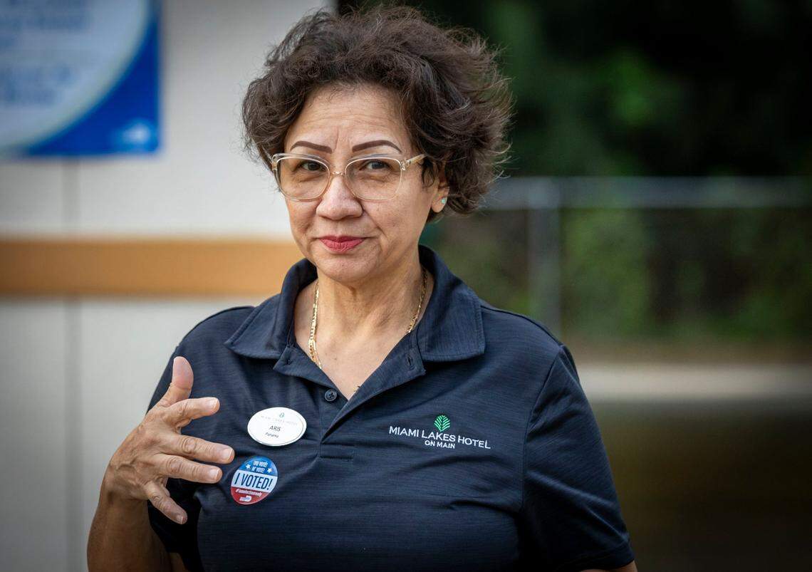 Miami, Florida, November 5, 2024 - A voter fixes an I voted sticker on her chest after voting at Miami-Dade County Fire Station #44, 7700 NW 186 St.