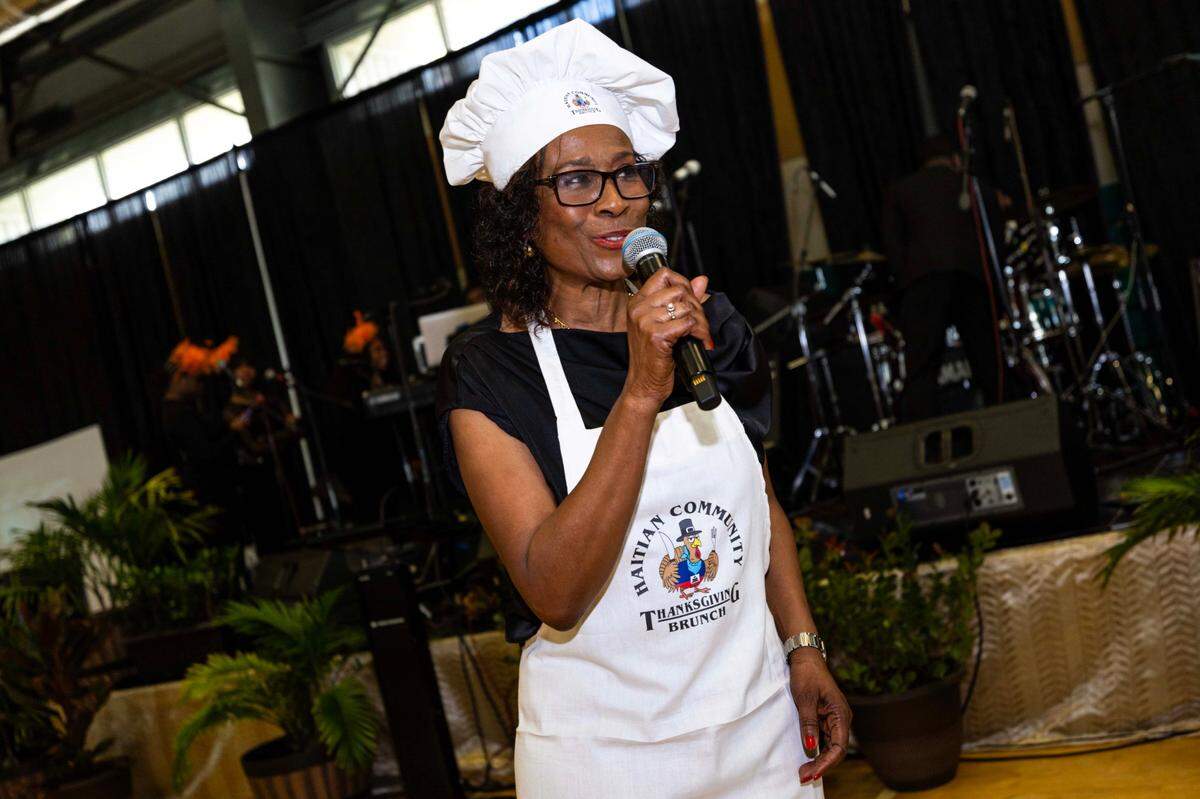 Organizer Emeline Schulz speaks to guests during the 18th Annual Haitian Thanksgiving Brunch hosted by The Schulz Foundation at the Joe Celestin Cente.