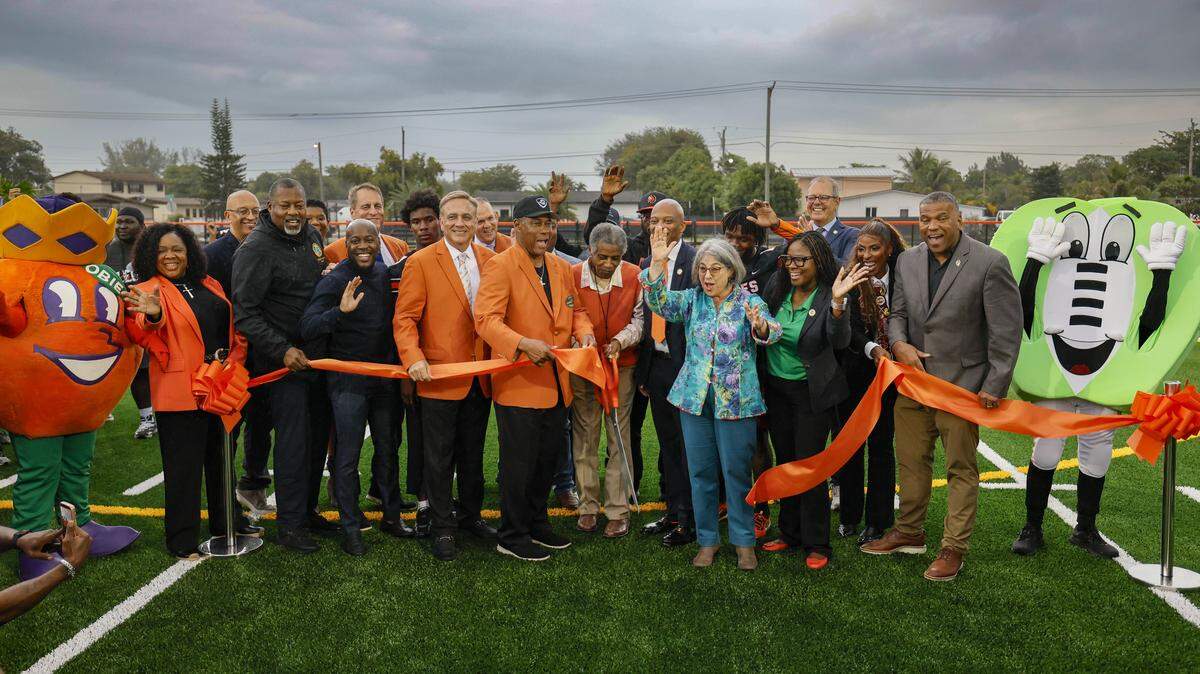 Nat Moore, Special Projects and Alumni Relations for the Miami Dolphins and Miami-Dade County Mayor Daniella Levine Cava and the Orange Bowl Commitee Members join Walt Frazier for a ribbon-cutting ceremony to open Orange Bowl Field at Walt Frazier Park on Tuesday, January 13, 2026 in Miami Gardens, Florida. The $2.3 million renovation includes a synthetic football field, an electronic scoreboard, and other refurbishments.