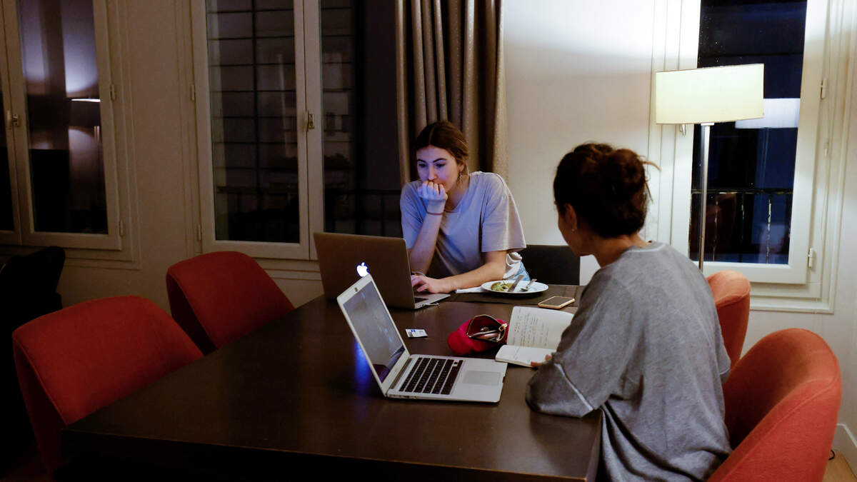 Jimena and Ana, both Spanish students in Erasmus program, are seen in their apartment after receiving a food bag and some sanitary items from the link association which offers all students, whether they have a scholarship or not, food baskets or meals already prepared freely twice a week, in Paris on January 28, 2021