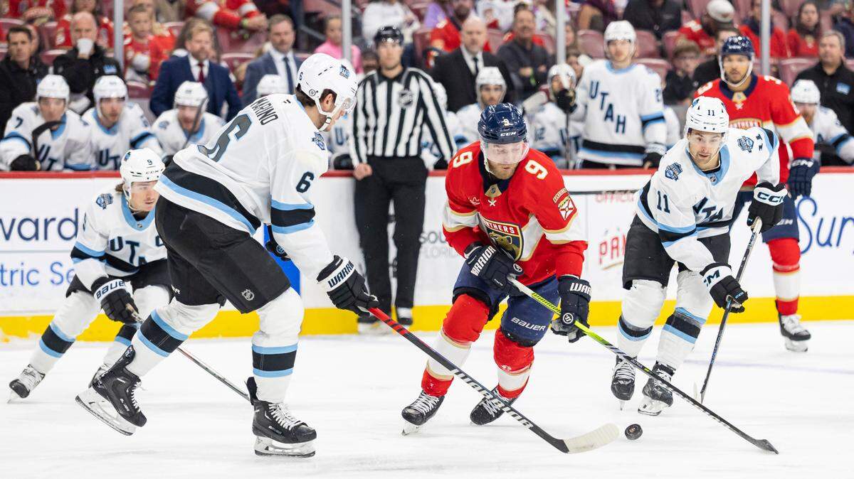 Florida Panthers center Sam Bennett (9) fights for the puck against Utah Hockey Club defenseman John Marino (6) and right wing Dylan Guenther (11) in the first period of their NHL game at Amerant Bank Arena on Friday, March 28, 2025, in Sunrise, Fla.