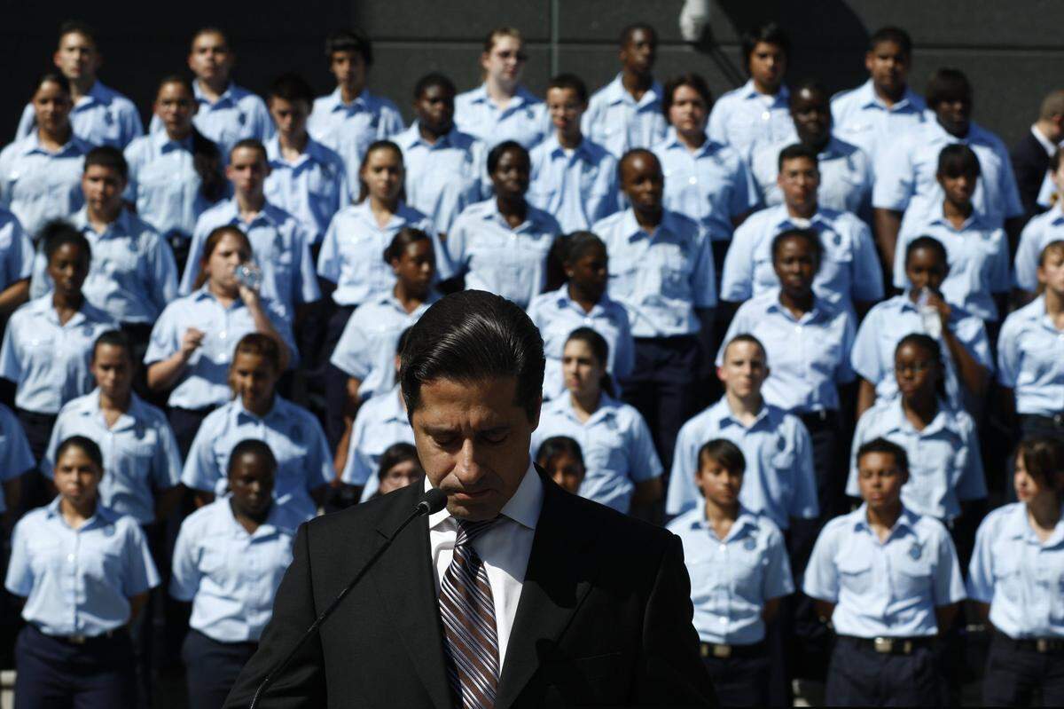 Miami-Dade Public Schools Superintendent Alberto Carvalho bows his head in a moment of silence for Miami-Dade students who have lost their lives during the school year, Oct. 19, 2009. Students of the district’s new high school law enforcement magnet program, Class of 2013, stand in formation behind Carvalho.