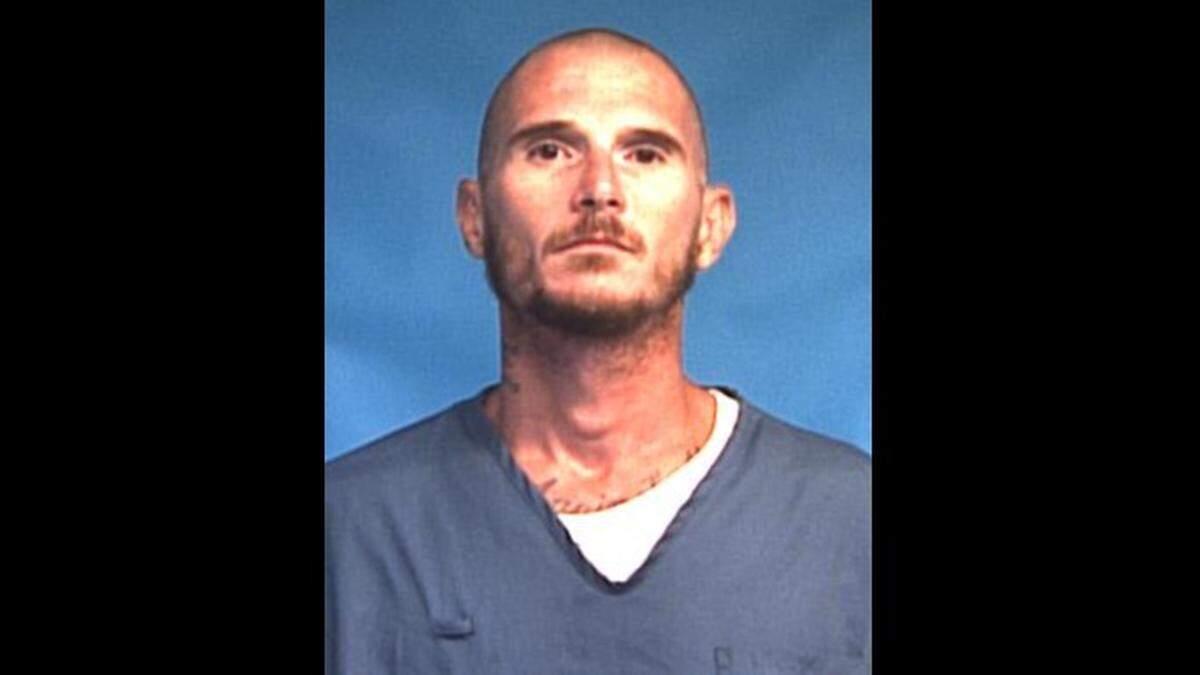 The Michael Prouty mugshot with the state corrections department’s online notification that he’d escaped on July 15.
