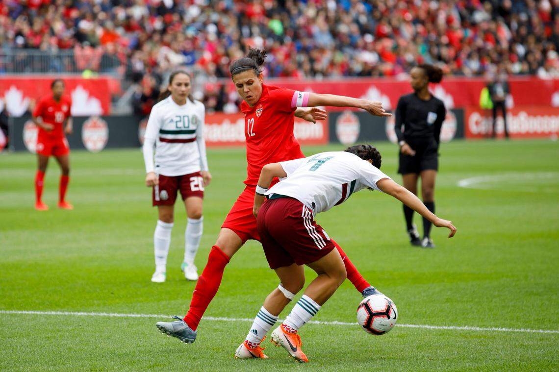 Canada’s Christine Sinclair (12) vies for the ball against Mexico defender Rebeca Orejel (4) during the second half of a women’s international friendly soccer match at BMO field in Toronto, Saturday, May 18, 2019.