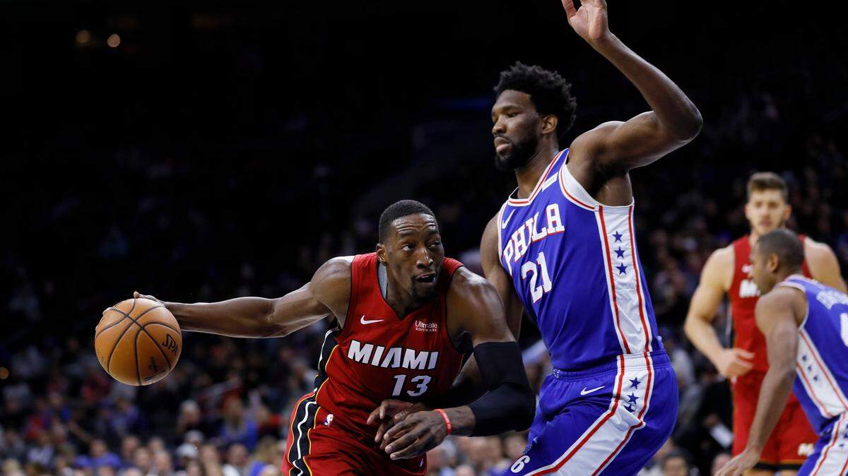Heat’s Bam Adebayo (13) tries to get around 76ers’ Joel Embiid (21) during the first half of an NBA basketball game, Wednesday, Dec. 18, 2019, in Philadelphia.
