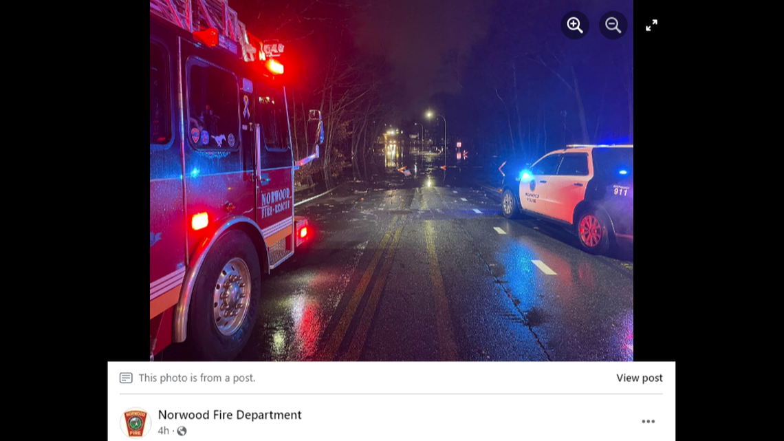 Rescuers found a driver hanging onto a tree after their car sank in floodwaters on a Massachusetts road, officials said.
