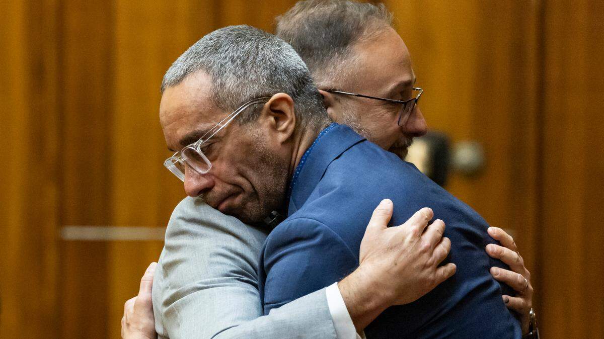 Daniel Lugo, in dark blue jacket, hugs his defense attorney Alex Sola are jurors sentenced him to life in prison in his resentencing trial at the Richard E. Gerstein Justice Building on Friday, Dec. 20, 2024, in Miami, Fla. The resentencing trial was held over a double murder three decades ago of a wealthy couple that ran a 900 phone sex business.
