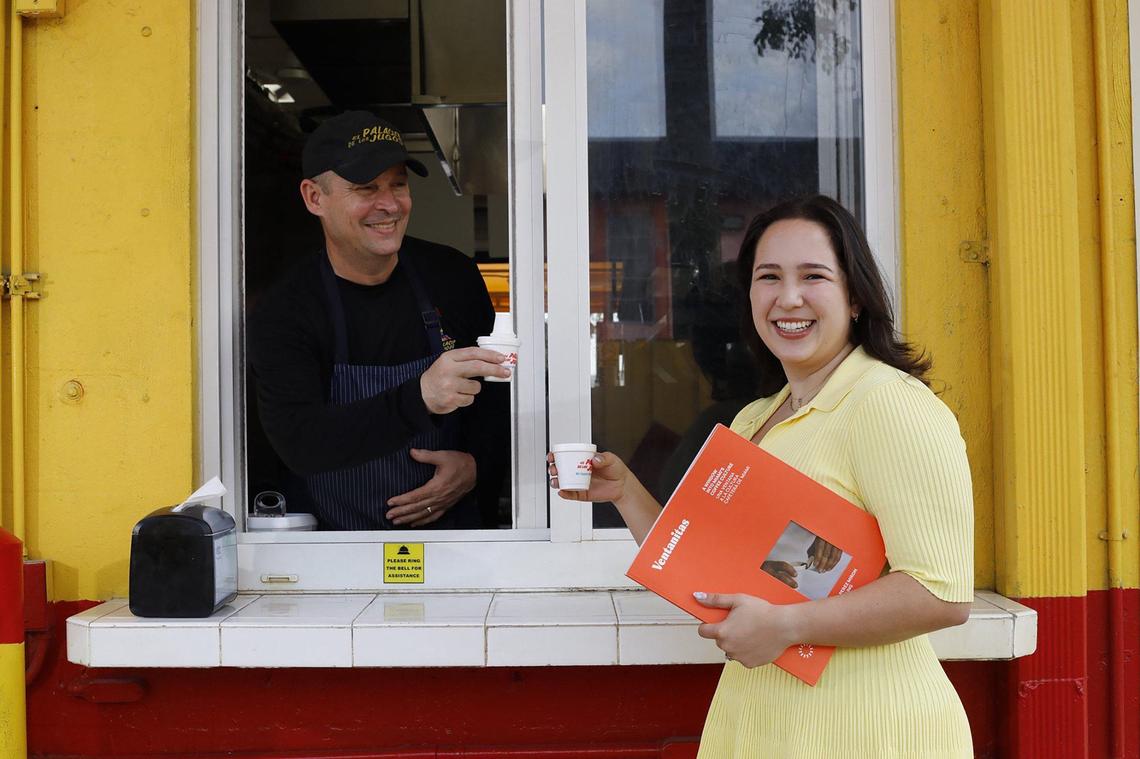 José Alejandro Fernandez serves cafecito’to Daniela Pérez Miron, author of the book ‘Ventanitas: A Window into Miami’s Coffee Culture,’ at El Palacio De Los Jugos, on Coral Way, Miami.