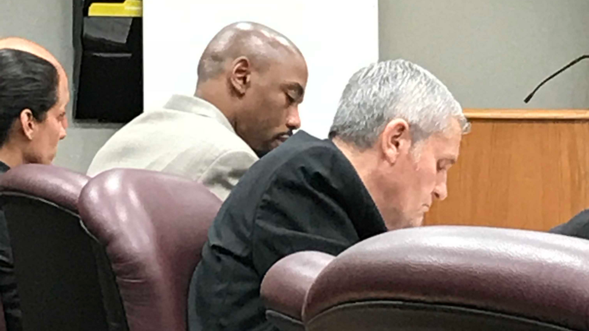 Suspected gang member Frantzy Jean-Marie sits next to his attorneys on Tuesday, waiting for a jury to decide if it will award him a death sentence of life in prison for the murder of a couple 15 years ago.