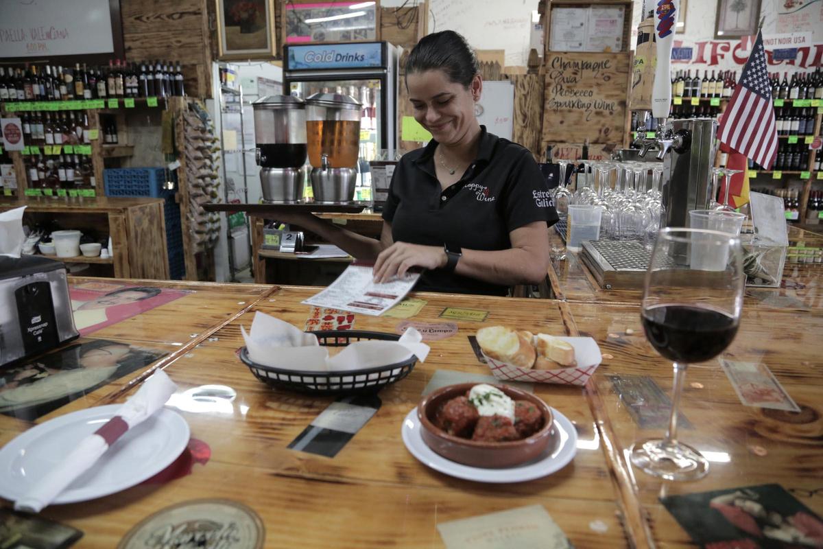 Longtime dedicated staff at the original Happy Wine location, such as Greta Figueredo, have helped J.C. Restrepo and Joanna Fajardo hold on to their slice of the American dream.