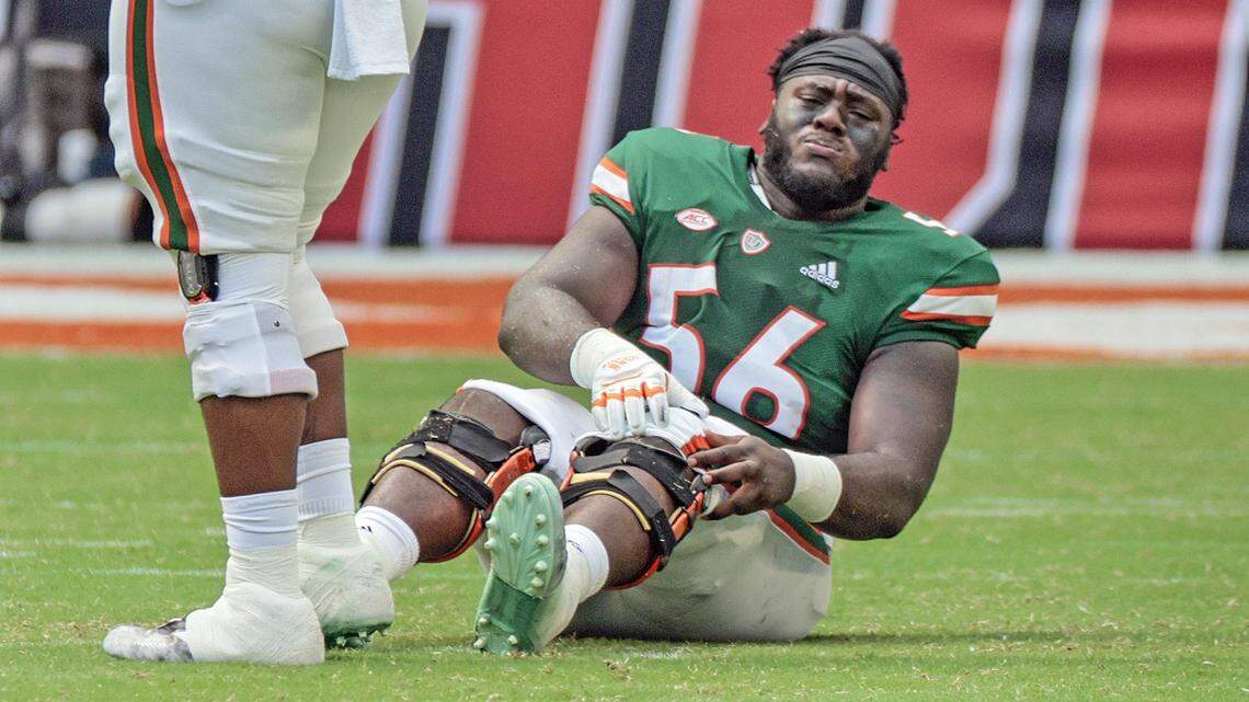 Miami Hurricanes offensive lineman Jonathan Denis (56) reacts after being injured during game against the Duke Blue Devils in the second quarter at Hard Rock Stadium in Miami Gardens on Saturday, October 22, 2022.