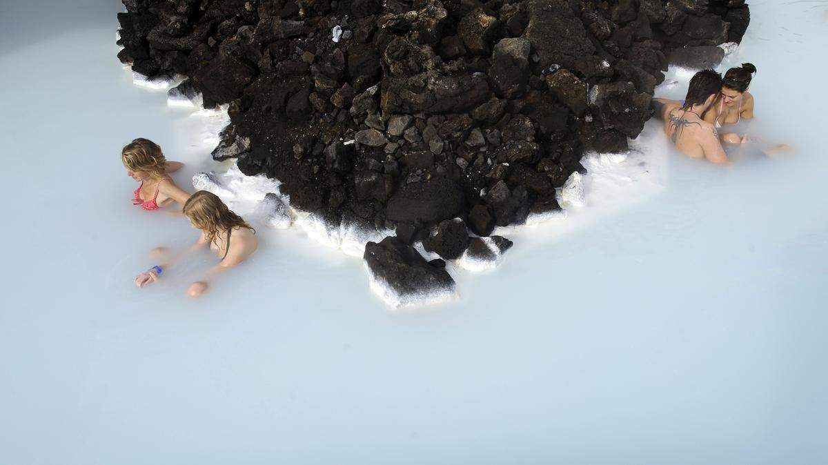 In this file picture taken on 26 April, 2009 tourists sit in the Blue Lagoon outside Reykjavik.