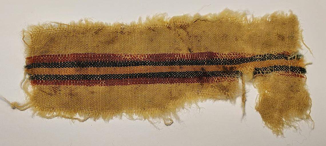 A red, blue and gold striped fabric found at Aravah.