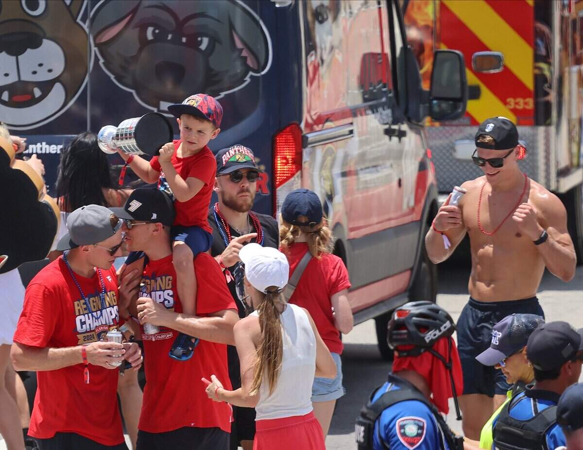 Panthers players and family members walk the parade route on both side of A1A just north of the staging area for the Florida Panthers Stanley Cup championship celebration parade on Sunday, June 22, 2025 in Fort Lauderdale, Florida.