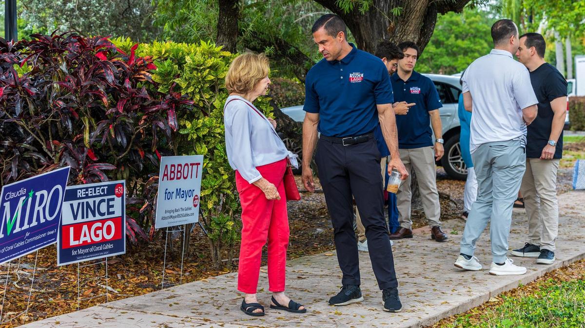 Coral Gables Mayor Vince Lago talks with residents as they arrive to vote at the Coral Gables Branch Library poll site on Tuesday, April 8, 2025.