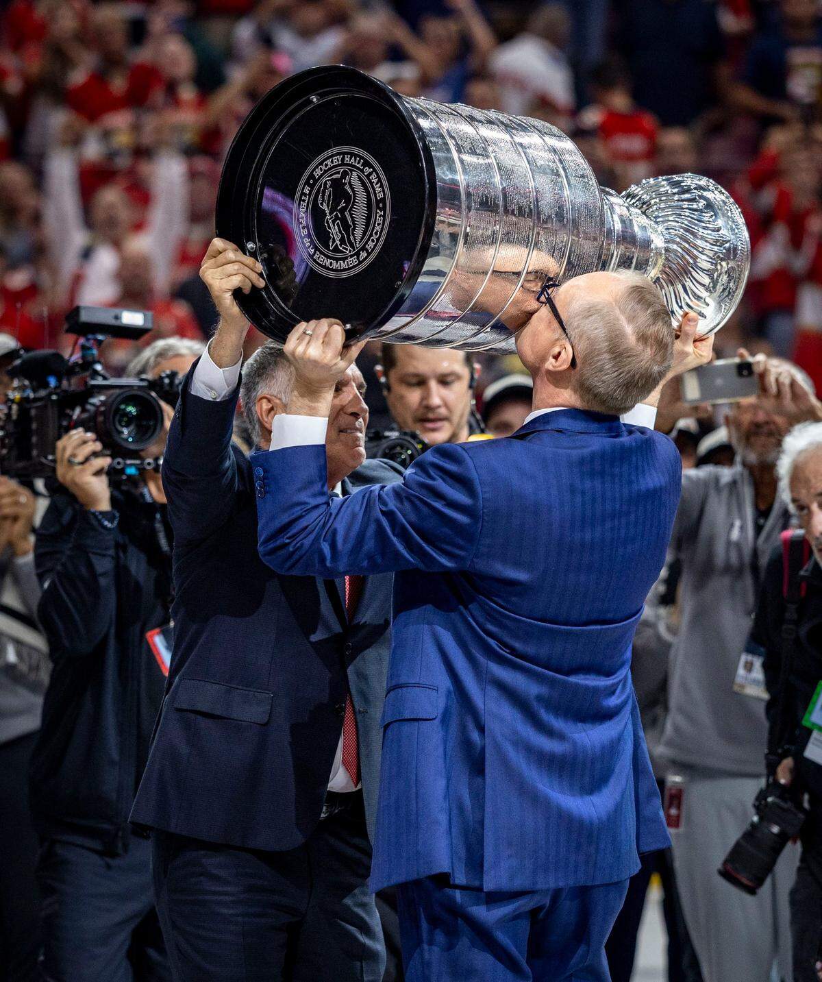 Florida Panthers owner Vincent J. Viola, left, hands off the Stanley Cup to Panthers head coach Paul Maurice during celebration on the ice after the Panthers defeated the Edmonton Oilers in Game 6 on