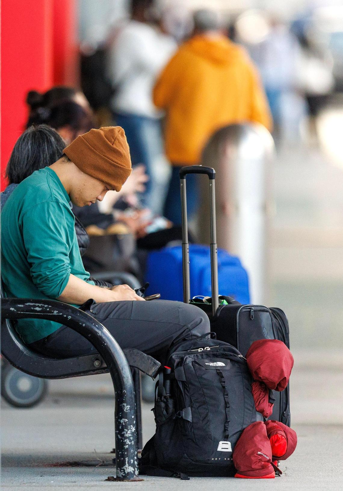 Travelers wait outside Terminal 2 at the Fort Lauderdale-Hollywood International Airport for flights to be resumed on Thursday, April 13, 2023 after the relentless rain and windy conditions prompted the airport, second largest in the region, to suspend arriving and departing flights on Wednesday.