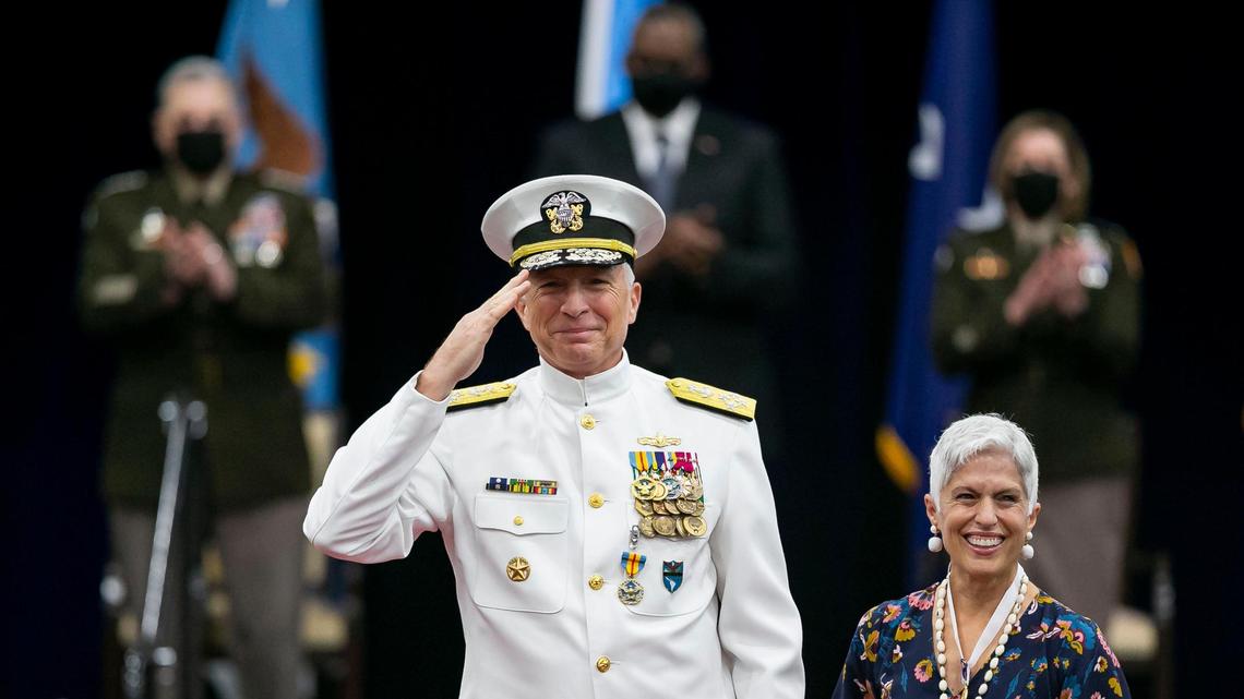 Outgoing commander of U.S. Southern Command Adm. Craig S. Faller salutes alongside his wife Martha Faller during a change-of-command ceremony at Southcom in Doral, Florida, on Friday, Oct. 29, 2021.