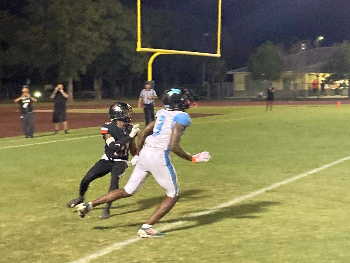 West Broward wide receiver Josh Moore battles Southridge defensive back Samuel Coleman for a pass in the end zone that Coleman came down with for an interception during Friday’s Region 4-6A final at Southridge Stadium in Miami.