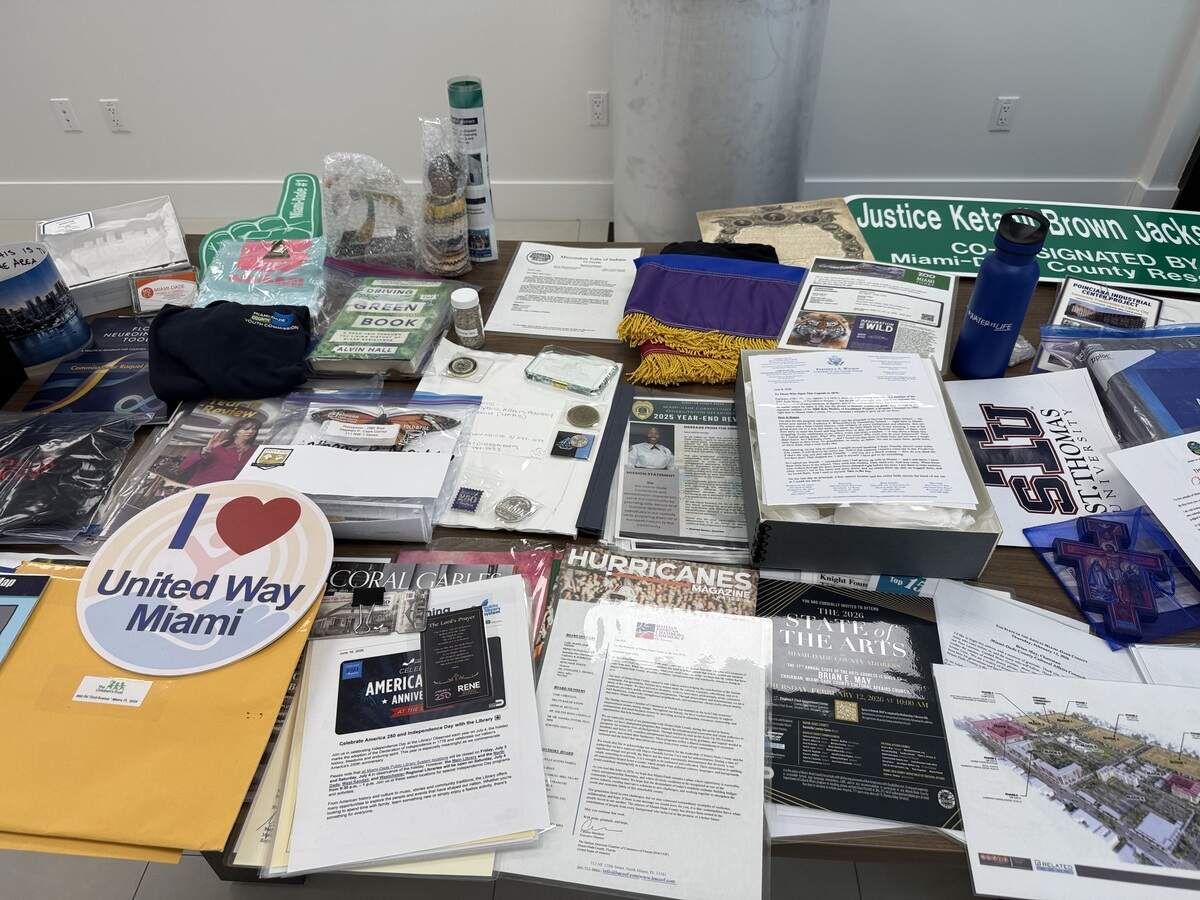 Some of the items Miami-Dade County selected to include in a 2026 time capsule placed in Tropical Park on June 29, 2026. The capsule, which includes a street sign honoring Palmetto High graduate and Supreme Court Justice Ketanji Brown Jackson, a University of Miami Hurricanes magazine, and a letter to the next generation from Mayor Daniella Levine Cava.
