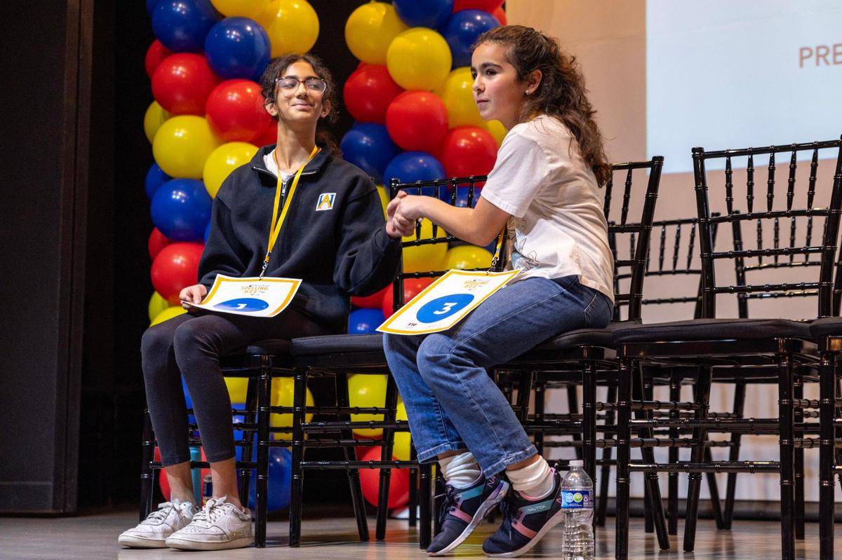 First Place winner Jasmine Perez from Bayview Elementary, right, shakes hands with second place winner Anvita Narasimhan from American Heritage School, left, during the Miami Herald Broward County Spelling Bee.