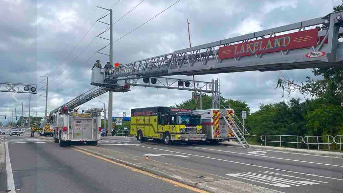 A man refused to come down from a platform of a railroad crossing, shutting down traffic for hours in Lakeland, Florida, police say