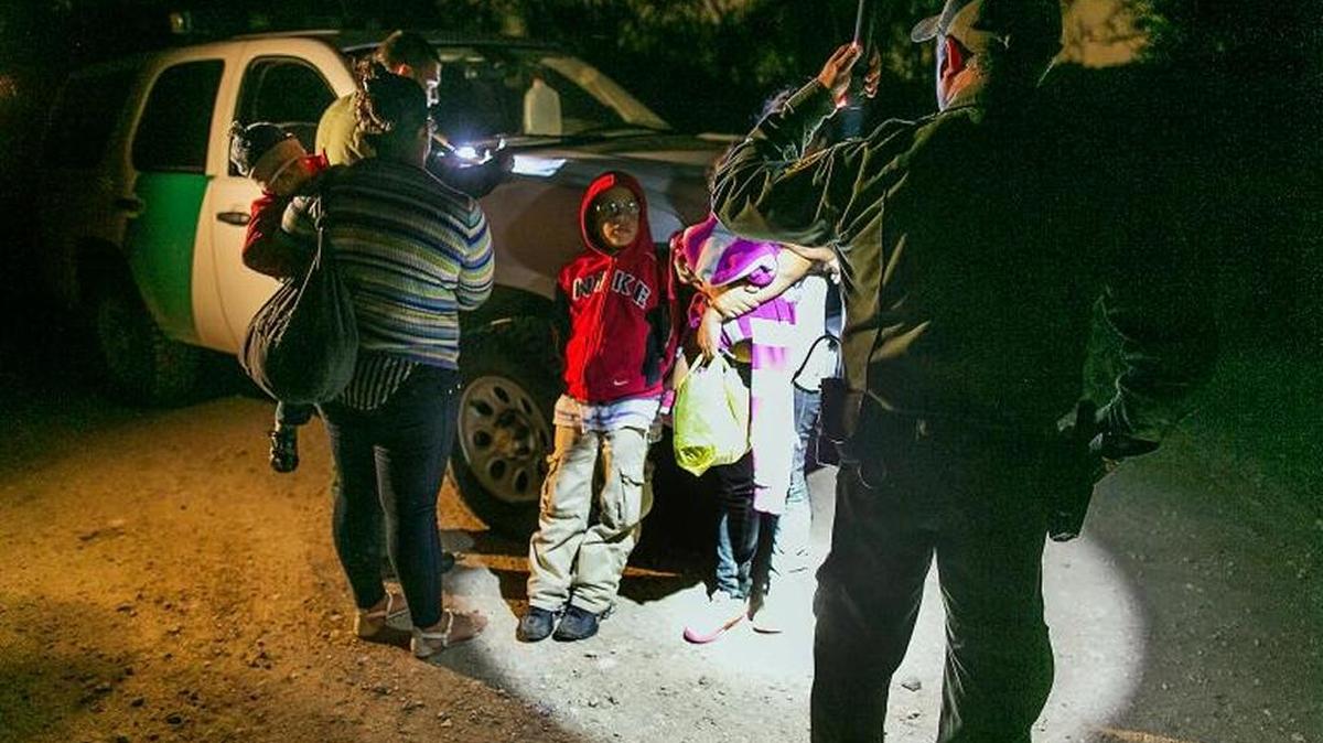 Honduran family gets into a U.S. Customs and Border Protection truck. They came escaping gang violence.