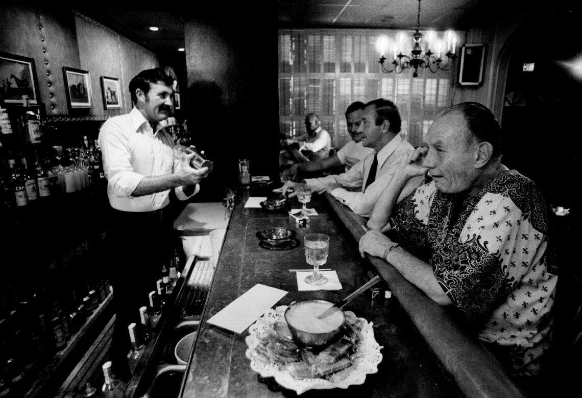 At the Riverside Hotel, 620 Las Olas Blvd., bartender John Hughes mixes drinks and talks with customers.
