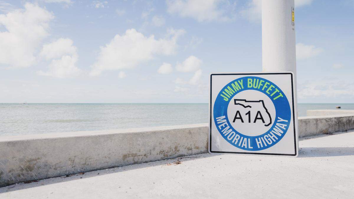 City officials from Key West, Sen. Lauren Book, Rep. Chuck Clemons, and Rep. Jim Mooney were joined by Jimmy Buffett’s family and Margaritaville executives for the official A1A Jimmy Buffett Memorial Highway Dedication on Aug. 30, 2024. The event also featured the unveiling of the A1A Jimmy Buffett Memorial Highway sign and an early rendering of the monument on a day dedicated to the late singer-songwriter.