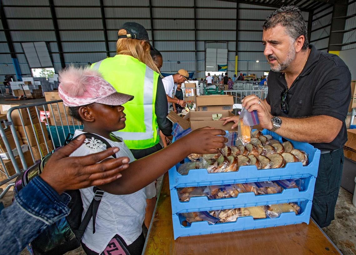 Chef Jacques Carlino of Blue Sail restaurant in Nassau, Bahamas, hands out sandwiches to Abaco evacuees of Hurricane Dorian as they arrive at the airport in the capital on Monday, Sept. 9, 2019.