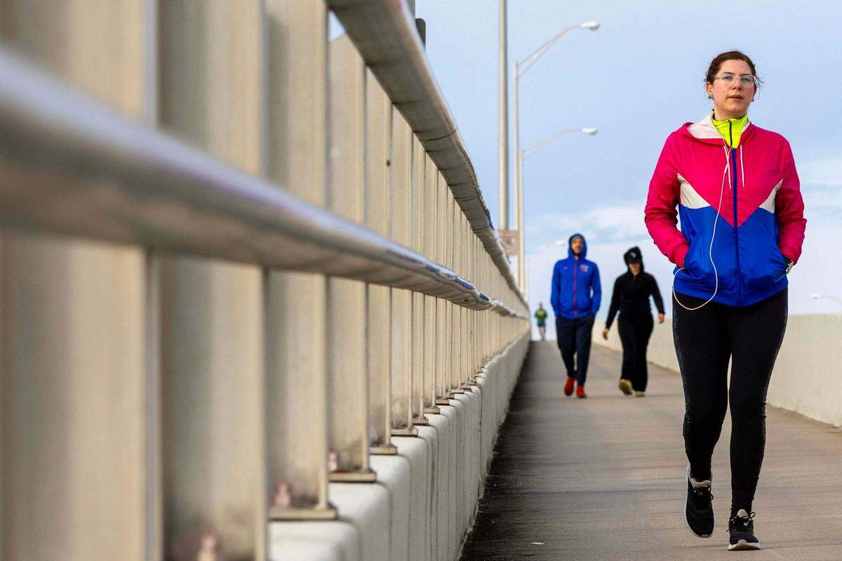 People walk on the William Powell Bridge along the Rickenbacker Causeway in Key Biscayne, Florida, on Saturday, December 24, 2022.