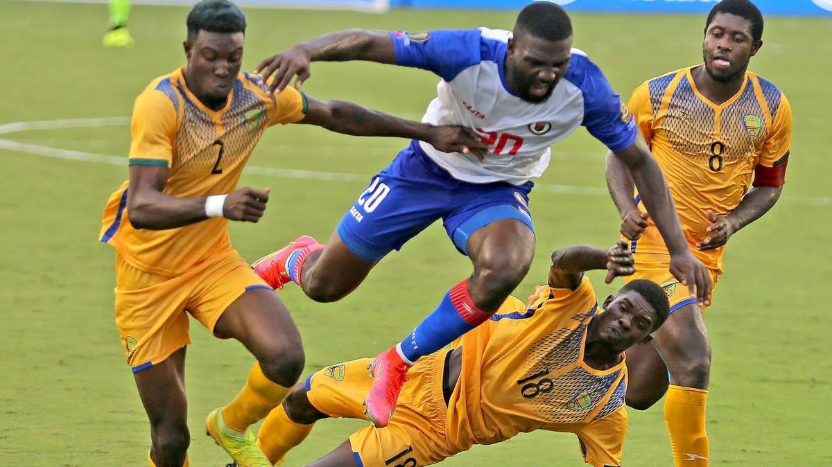 Haiti’s Frantzdy Pierrot (20) leaps through Saint Vincent players as he pushes to the goal late in the second half in the 2021 Gold Cup preliminary round matches at DRV PNK Stadium in Fort Lauderdale, July 2, 2021.