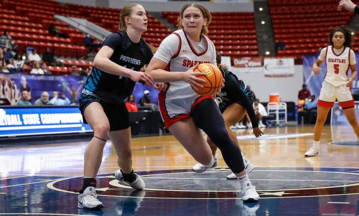 Miami Country Day’s Jalynn Belton (13) drives to the basket as Providence School’s Kasey Davey (14) defends in the second half of the FHSAA Class 2A Girls High School Basketball State Championship.