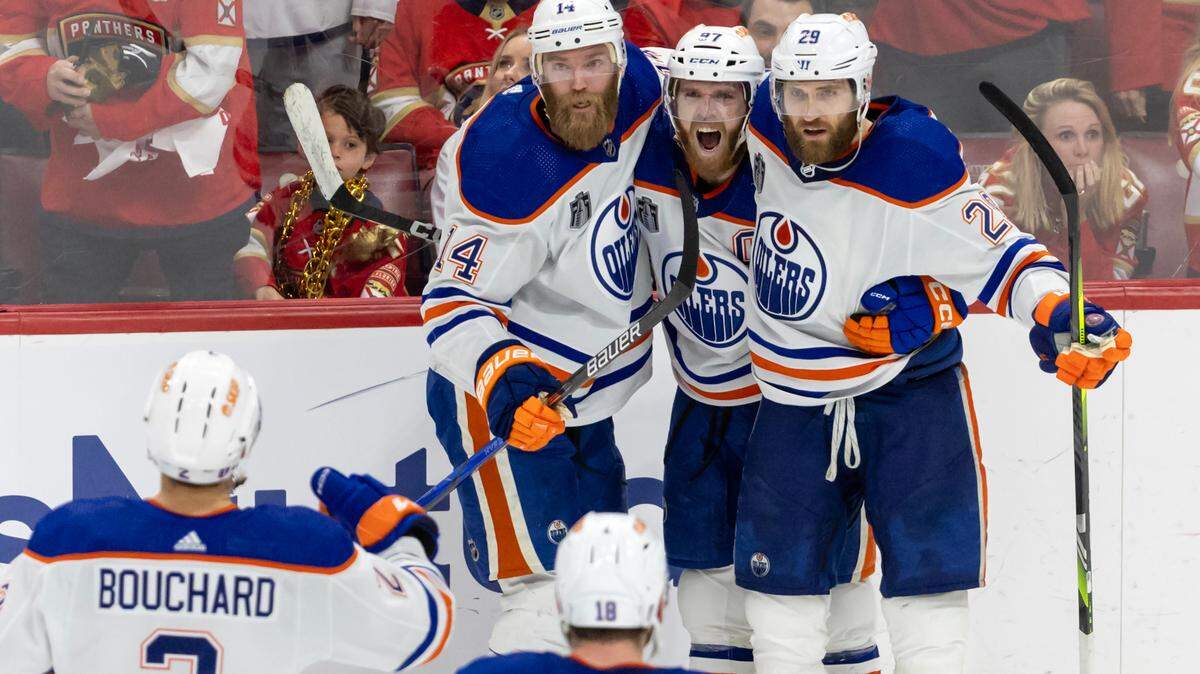 Edmonton Oilers center Connor McDavid (97) celebrates with teammates after scoring a goal against Florida Panthers during the third period of Game 5 of the NHL Stanley Cup Final at the Amerant Bank Arena on Tuesday, June 18, 2024, in Sunrise, Fla.