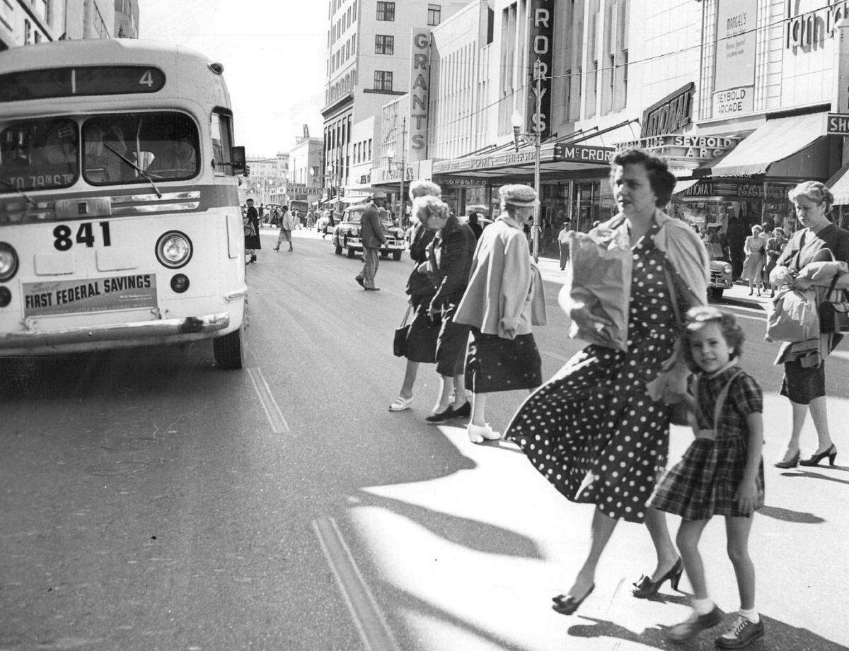 Pedestrians near a county bus on Flagler Street in 1954.