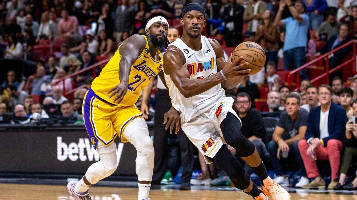 Miami Heat forward Jimmy Butler (22) drives past Los Angeles Lakers point guard Patrick Beverley (21) during the second half of an NBA game at FTX Arena in Downtown Miami on Wednesday, December 28, 2022.