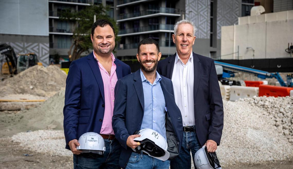 PMG managing partners Dan Kaplan and Ryan Shear, left and center, stand with company founder and CEO Kevin Maloney at the construction site for their Waldorf Astoria Hotel & Residences on Biscayne Boulevard in downtown Miami. The Waldorf is the first supertall tower to break ground in Miami.
