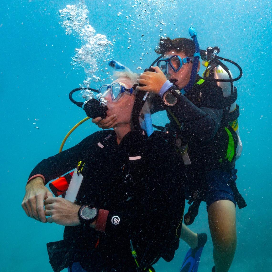 Master diver Matteo Miller, 12, right, practices assisting an unconscious diver, on his his father Paul Miller, left, during an ocean dive session on Friday, August 9, 2024, in Key Biscayne, Fla. Miller received the master diver certification after completing his Rescue diver certification.
