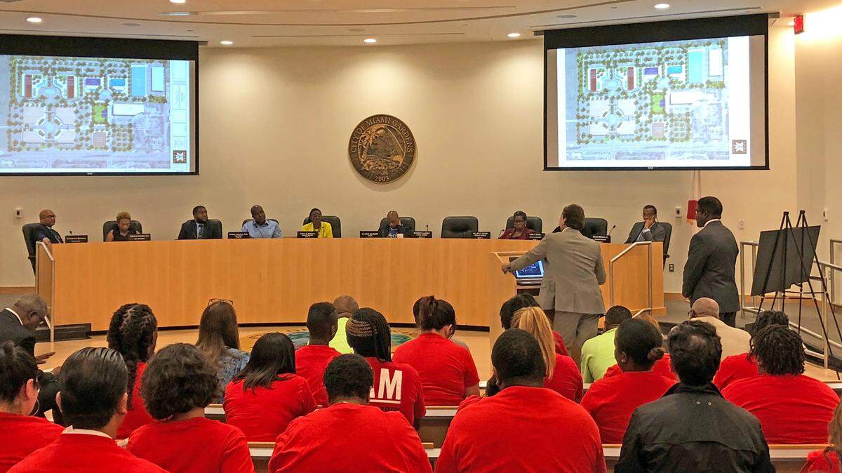 Union members in red shirts sit in the audience at Miami Gardens City Hall as the City Commission hears a presentation about development.  Three of the six commission seats were up for election in 2018, and only one was filled during the August elections.