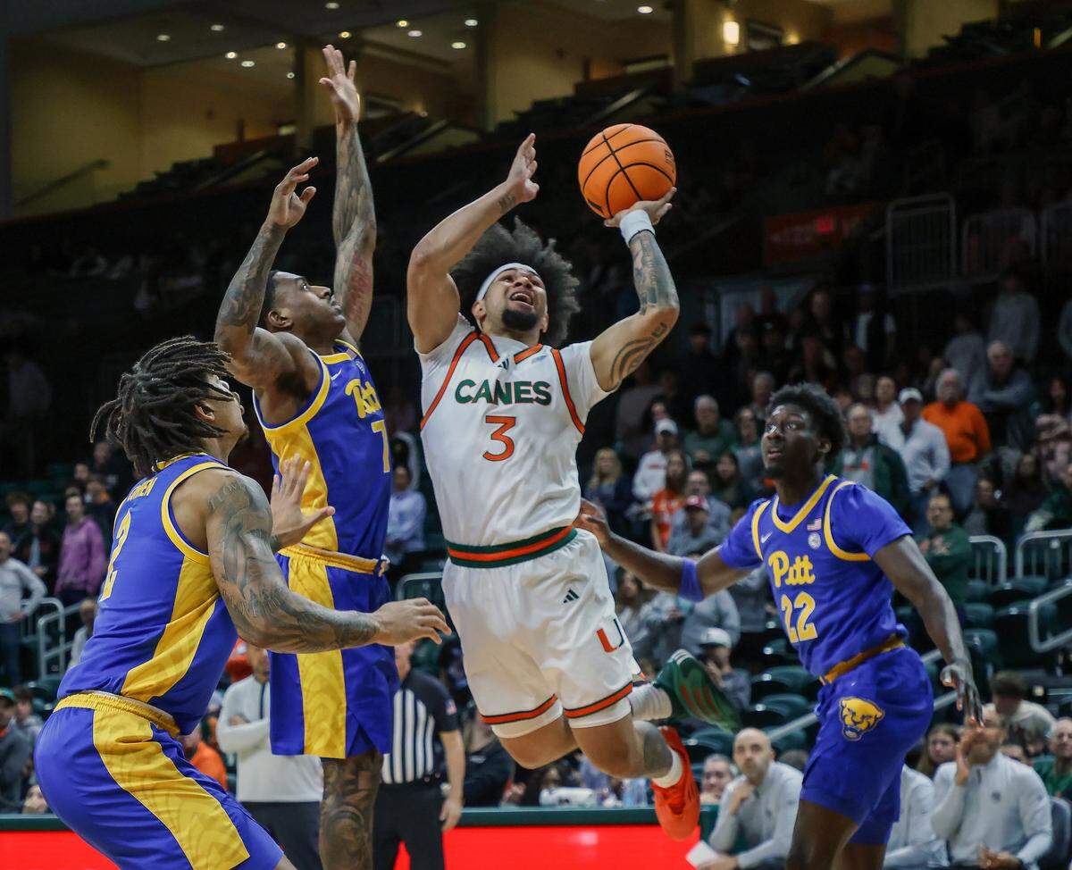 UM guard Tre Donaldson, center, drives pass Pitt players in the first half as University of Miami (11-2) Men's basketball played against Pittsburgh (7-6) in the ACC opener at the Watsco Center in Coral Gables, Florida, on Sunday, December 14, 2025.