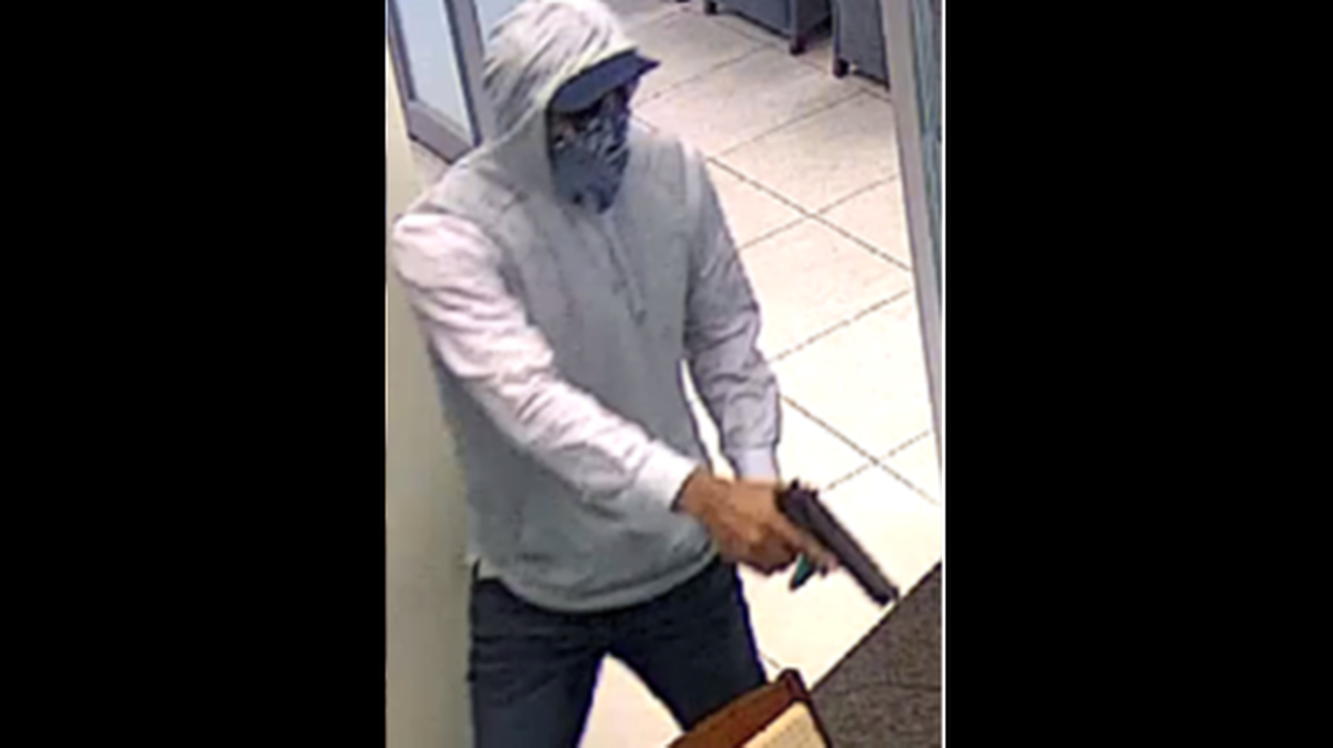 Surveillance cameras captured the suspect during the robberies. In some of the photos, he’s holding a gun, wearing a cap under the hoodie, sunglasses and a bandana to cover his face.