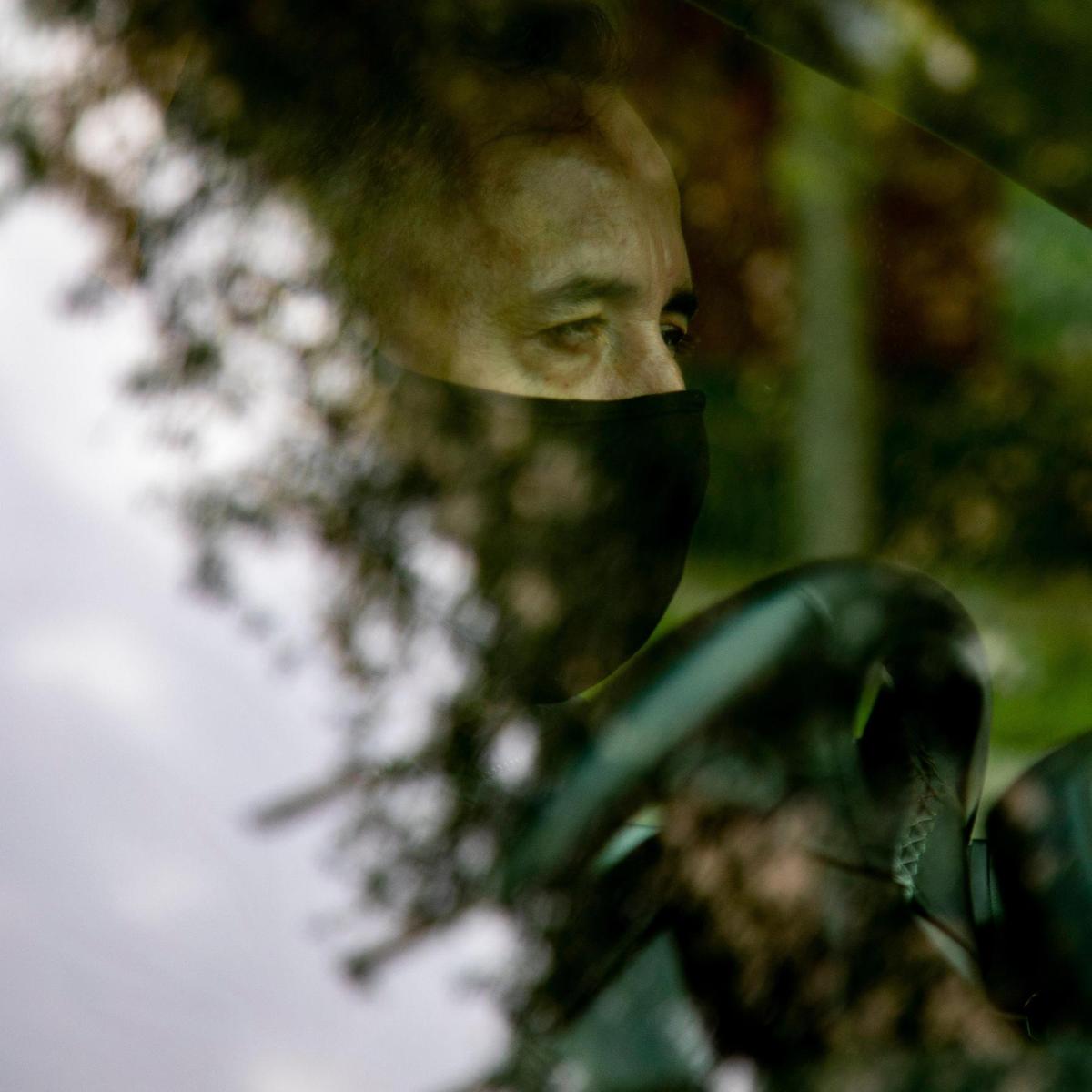 Colombian comedian Julio Rodríguez waits in his car in Homestead while out on delivery for Lean Culinary Services LLC, a subcontractor that delivers meals to the needy all over Miami-Dade on May 26, 2020. Later in the evenings, Rodríguez performs in his YouTube show called Politicamente en su recto, a Spanish language play on words, with other renowned Latin American comedians.
