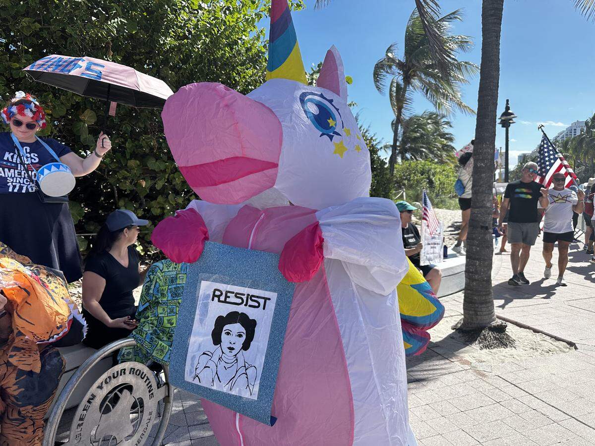 A woman in an inflatable unicorn outfit at a “No Kings” day protest.
